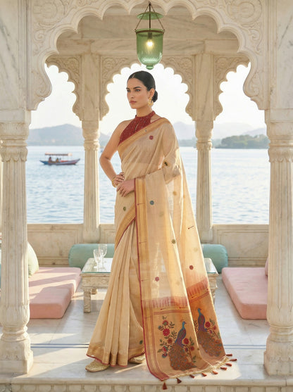 Woman in a traditional saree standing in an elegant outdoor setting with architectural elements and a scenic background. Cream Banarasi Style Jamdani Cotton Saree for women