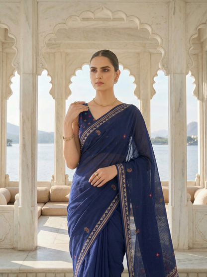 Woman in a blue saree standing in an architectural setting with a scenic background Navy Blue Patola Jamdani Cotton Saree for women