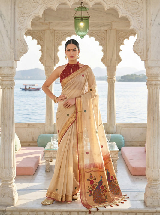 Woman in a traditional saree standing in an ornate architectural setting with a scenic background. Cream Banarasi Style Jamdani Cotton Saree for women